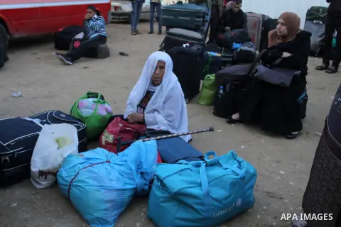 Palestinians wait for a travel permit to cross into Egypt through the Rafah border crossing between Egypt and the southern Gaza Strip February 14, 2016. Egypt opened the Rafah border crossing on Saturday for two days to...