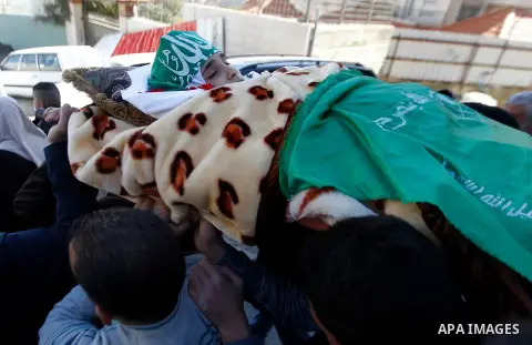 Mouerners cary the body of Kalzar al-Uweiwi, a Palestinian teenager who was killed a day earlier following a reported stabbing attack, during her funeral, in the West Bank city of Hebron, February 14, 2016. Israeli force...