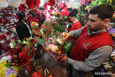 Palestinian vendors display flowers red teddy bears and pillows on Valentine's day in Gaza on February 14, 2016. Valentine's Day is increasingly popular in the region as people have taken up the custom of giving flowers,...