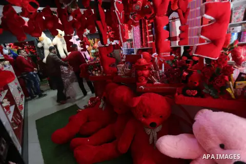 Palestinian vendors display flowers red teddy bears and pillows on Valentine's day in Gaza on February 14, 2016. Valentine's Day is increasingly popular in the region as people have taken up the custom of giving flowers,...