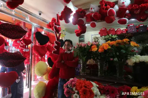 Palestinian vendors display flowers red teddy bears and pillows on Valentine's day in Gaza on February 14, 2016. Valentine's Day is increasingly popular in the region as people have taken up the custom of giving flowers,...