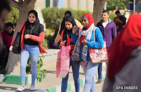 Egyptian students celebrate on Valentine's day at Cairo University, in Cairo on February 14, 2016. Valentine's Day is increasingly popular in the region as people have taken up the custom of giving flowers, cards, chocol...