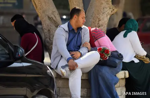 Egyptian students celebrate on Valentine's day at Cairo University, in Cairo on February 14, 2016. Valentine's Day is increasingly popular in the region as people have taken up the custom of giving flowers, cards, chocol...