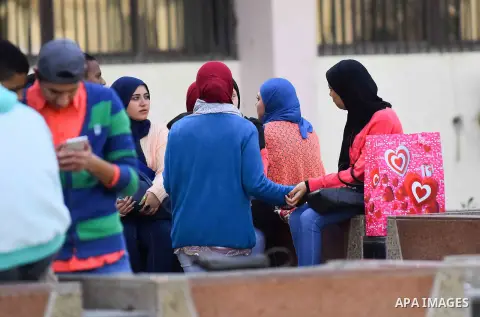 Egyptian students celebrate on Valentine's day at Cairo University, in Cairo on February 14, 2016. Valentine's Day is increasingly popular in the region as people have taken up the custom of giving flowers, cards, chocol...