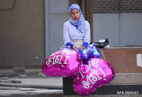 Egyptian students celebrate on Valentine's day at Cairo University, in Cairo on February 14, 2016. Valentine's Day is increasingly popular in the region as people have taken up the custom of giving flowers, cards, chocol...