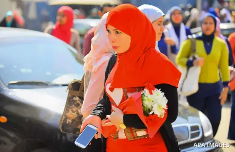 Egyptian students celebrate on Valentine's day at Cairo University, in Cairo on February 14, 2016. Valentine's Day is increasingly popular in the region as people have taken up the custom of giving flowers, cards, chocol...