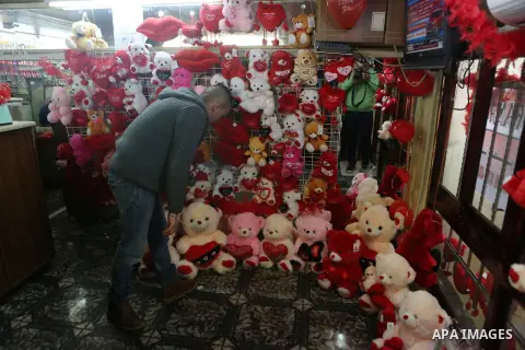 Palestinian vendors display flowers red teddy bears and pillows on Valentine's day in the West Bank city of Ramallah, on February 14, 2016. Valentine's Day is increasingly popular in the region as people have taken up th...