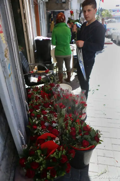 Palestinian vendors display flowers red teddy bears and pillows on Valentine's day in the West Bank city of Ramallah, on February 14, 2016. Valentine's Day is increasingly popular in the region as people have taken up th...