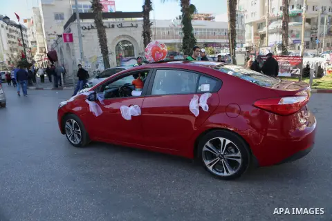 A Palestinian man rides a red car on Valentine's day in the West Bank city of Ramallah, on February 14, 2016. Valentine's Day is increasingly popular in the region as people have taken up the custom of giving flowers, ca...