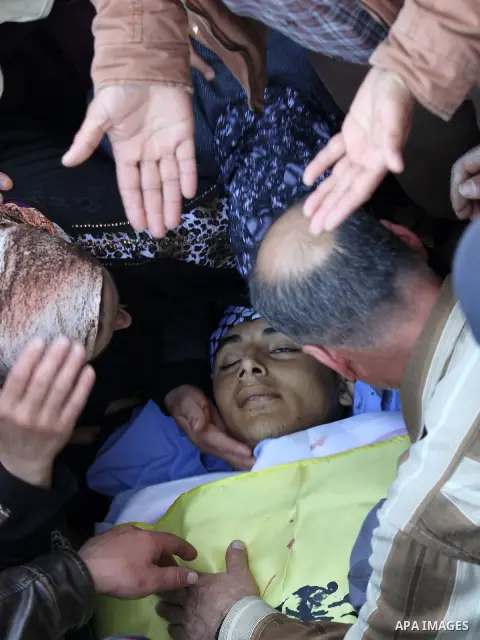 Relatives of Palestinian Nihad Waked who was shot dead by Israeli security forces as they reported fired on Israeli soldiers mourn over his body during his funeral on February 14, 2016 in the village of Araka, West of Je...