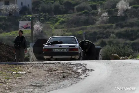 Israeli security forces inspect a car during clashes with Palestinian protesters in the village of Araka, West of Jenin in the Israeli occupied West Bank on February 15, 2016. Photo by Nedal Eshtayah