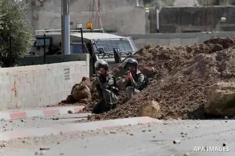 Israeli security forces stand in position during clashes with Palestinian protesters in the village of Araka, West of Jenin in the Israeli occupied West Bank on February 15, 2016. Photo by Nedal Eshtayah