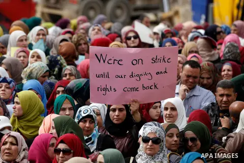 Palestinian teachers take part in a protest to demand their rights, in the West bank city of Hebron, on February 18, 2016. Photo by Wisam Hashlamoun