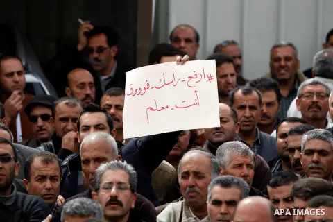 Palestinian teachers take part in a protest to demand their rights, in the West bank city of Hebron, on February 18, 2016. Photo by Wisam Hashlamoun