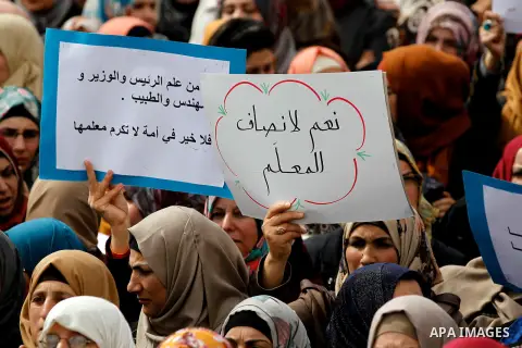 Palestinian teachers take part in a protest to demand their rights, in the West bank city of Hebron, on February 18, 2016. Photo by Wisam Hashlamoun