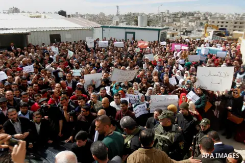 Palestinian teachers take part in a protest to demand their rights, in the West bank city of Hebron, on February 18, 2016. Photo by Wisam Hashlamoun