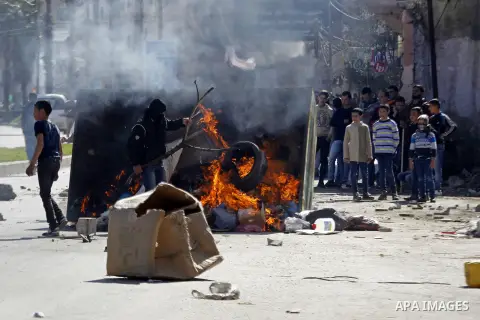 Palestinian protesters burn tires during clashes with Israeli security forces (unseen) to show solidarity with Mohammed al-Qiq a Palestinian prisoner on hunger strike, in the West bank city of Hebron on February 19, 2016...