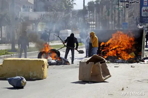 Palestinian protesters burn tires during clashes with Israeli security forces (unseen) to show solidarity with Mohammed al-Qiq a Palestinian prisoner on hunger strike, in the West bank city of Hebron on February 19, 2016...