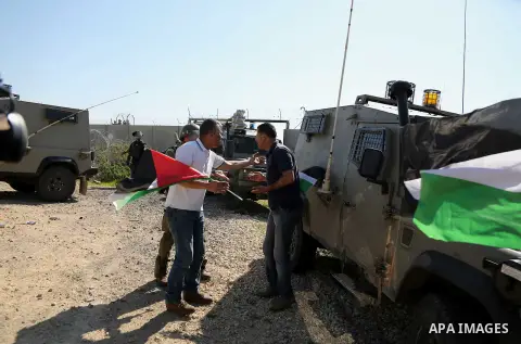 A Palestinian man argues with a member of Israeli security forces during clashes with Israeli security forces following a march on February 19, 2016 in the West Bank village of Bilin, near Ramallah, to mark the 11th anni...