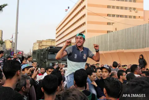 Egyptian Mourners protest the death of Mohamed Ali Sayed Ismail, a 23 year-old driver, who was shot dead overnight during a dispute with a police sergeant, ouside local security headquarters in Cairo, Egypt, Friday, Feb....