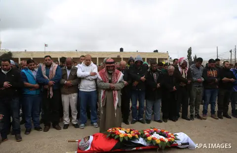 Mourners pray on the body of Abed Hammad, 20, who was shot dead by Israeli forces, during his funeral in the West Bank village of Silwad, Feb. 20, 2016. Hammad was one of three Palestinians to be killed by Israeli forces...