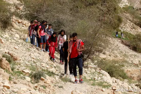 Palestinian youths walk on the mountains of Wadi Qelt, near the West Bank city of Jericho, on Feb 20, 2016. Wadi Qelt is a valley running west to east across the Judean desert in the West Bank, originating near Jerusalem...