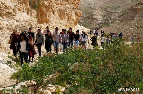 Palestinian youths walk on the mountains of Wadi Qelt, near the West Bank city of Jericho, on Feb 20, 2016. Wadi Qelt is a valley running west to east across the Judean desert in the West Bank, originating near Jerusalem...