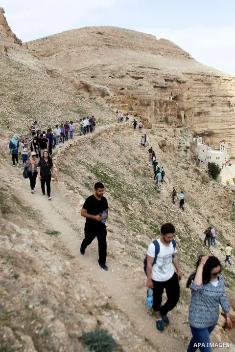 Palestinian youths walk on the mountains of Wadi Qelt, near the West Bank city of Jericho, on Feb 20, 2016. Wadi Qelt is a valley running west to east across the Judean desert in the West Bank, originating near Jerusalem...