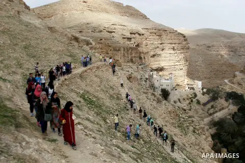 Palestinian youths walk on the mountains of Wadi Qelt, near the West Bank city of Jericho, on Feb 20, 2016. Wadi Qelt is a valley running west to east across the Judean desert in the West Bank, originating near Jerusalem...