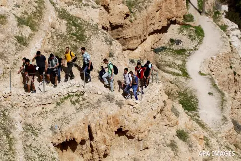 Palestinian youths walk on the mountains of Wadi Qelt, near the West Bank city of Jericho, on Feb 20, 2016. Wadi Qelt is a valley running west to east across the Judean desert in the West Bank, originating near Jerusalem...