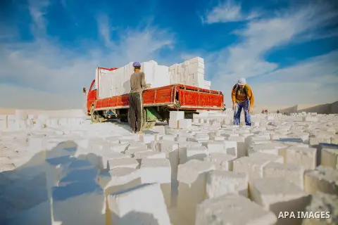 Egyptian Labourers work at a quarry in the desert of Minya governorate, south of Cairo, Egypt, on Feb 20, 2016. In the limestone quarries of Minya province south of Cairo, labourers in sandals and makeshift masks use uns...