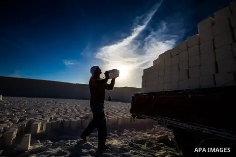Egyptian Labourers work at a quarry in the desert of Minya governorate, south of Cairo, Egypt, on Feb 20, 2016. In the limestone quarries of Minya province south of Cairo, labourers in sandals and makeshift masks use uns...
