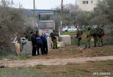 Israeli soldiers secure the scene after a Palestinian man who tried to stab an Israeli soldier before being shot dead, at the Bitot Junction south of Nablus in the northern occupied West Bank, on February 21, 2016. "A Pa...