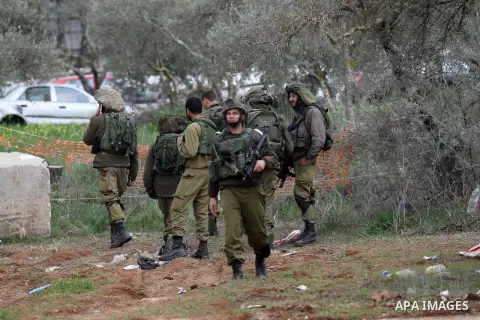 Israeli soldiers secure the scene after a Palestinian man who tried to stab an Israeli soldier before being shot dead, at the Bitot Junction south of Nablus in the northern occupied West Bank, on February 21, 2016. "A Pa...