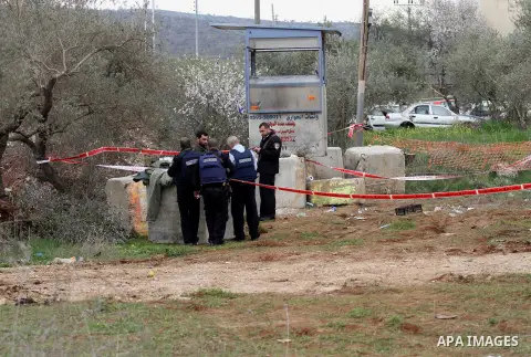 Israeli soldiers secure the scene after a Palestinian man who tried to stab an Israeli soldier before being shot dead, at the Bitot Junction south of Nablus in the northern occupied West Bank, on February 21, 2016. "A Pa...