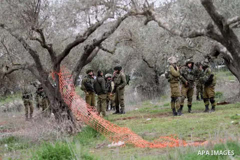 Israeli soldiers secure the scene after a Palestinian man who tried to stab an Israeli soldier before being shot dead, at the Bitot Junction south of Nablus in the northern occupied West Bank, on February 21, 2016. "A Pa...