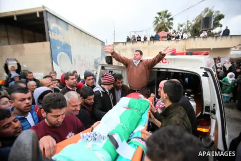 Mourners carry the the body of Palestinian teenager Qusay Abo Alrob, 16, whom the Israeli military said was shot dead by Israeli troops after he tried to stab a soldier on Sunday, during his funeral in the West Bank town...