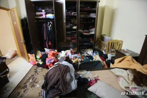 A Palestinian boy looks at the bedroom after Israeli troops searched apartments belonging to a same family during an operation to arrest wanted Palestinians in the Askar refugee camp, near Nablus in the Israeli occupied...