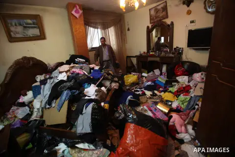 A Palestinian man looks at the bedroom after Israeli troops searched apartments belonging to a same family during an operation to arrest wanted Palestinians in the Askar refugee camp, near Nablus in the Israeli occupied...