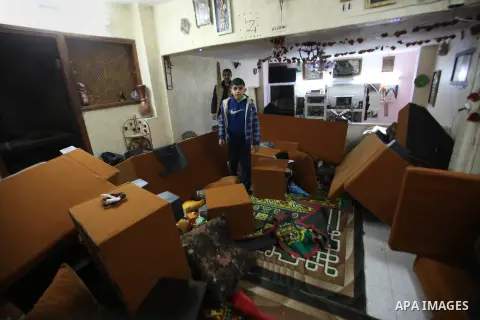A Palestinian boy looks at the bedroom after Israeli troops searched apartments belonging to a same family during an operation to arrest wanted Palestinians in the Askar refugee camp, near Nablus in the Israeli occupied...