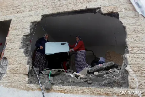 Palestinians check the damage in a house after it was partially demolished by Israeli forces in the West Bank village of Deir Samit, south of Hebron February 23, 2016. Israeli army on Tuesday demolished houses of two Pal...