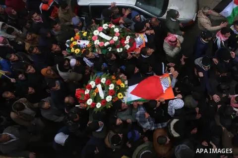 Palestinian mourners carry the bodies of Mansour al-Shawamrah, 20, and Omar Amr, 20 during their joint funeral in the West Bank village of al-Qubeiba, near Ramallah, Tuesday, Feb. 23, 2016. Israeli police said that the t...
