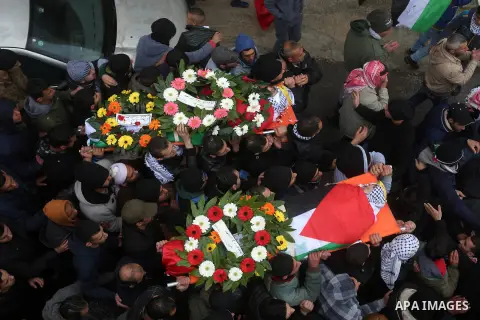 Palestinian mourners carry the bodies of Mansour al-Shawamrah, 20, and Omar Amr, 20 during their joint funeral in the West Bank village of al-Qubeiba, near Ramallah, Tuesday, Feb. 23, 2016. Israeli police said that the t...