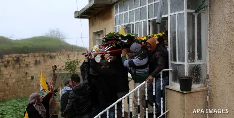 Palestinian mourners carry the body of one of two Palestinians, who the Israeli military said were fatally shot by Israeli police officers after they opened fire at them outside Jerusalem's walled Old City on February 14...