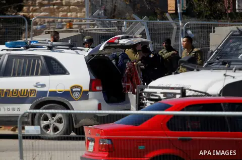 An Israeli police officer inspects the scene of an attack at the Gush Etzion junction in the West Bank, Wednesday, Feb. 24, 2016. The Israeli military says a knife-wielding Palestinian rushed toward an Israeli in the Wes...