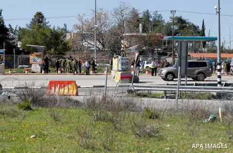 Israeli soldiers gather at the scene of an attack at the Gush Etzion junction in the West Bank, Wednesday, Feb. 24, 2016. The Israeli military says a knife-wielding Palestinian rushed toward an Israeli in the West Bank a...