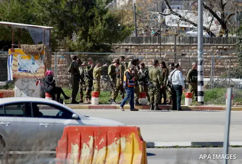 Israeli soldiers gather at the scene of an attack at the Gush Etzion junction in the West Bank, Wednesday, Feb. 24, 2016. The Israeli military says a knife-wielding Palestinian rushed toward an Israeli in the West Bank a...
