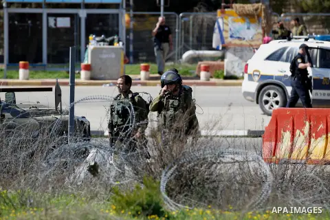 Israeli soldiers gather at the scene of an attack at the Gush Etzion junction in the West Bank, Wednesday, Feb. 24, 2016. The Israeli military says a knife-wielding Palestinian rushed toward an Israeli in the West Bank a...