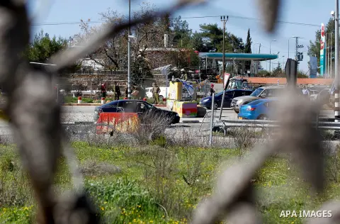 Israeli soldiers gather at the scene of an attack at the Gush Etzion junction in the West Bank, Wednesday, Feb. 24, 2016. The Israeli military says a knife-wielding Palestinian rushed toward an Israeli in the West Bank a...