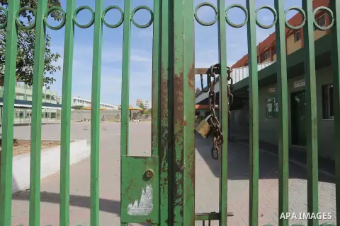 A Palestinian man walks past a closed school during the strike of the employees of former Palestinian government in Gaza Strip and West bank to demand for pay their salaries, in Gaza city on February 25, 2016. Photo by M...